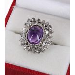 18ct white gold amethyst and diamond cluster ring, with a central amethyst cabouchon in a surround