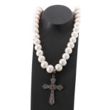 Row of cultured pearls with a diamond and ruby cross pendant, the pearls 11-13mm, 106.3gm, 20" long,