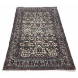 Persian allover patterned rug, navy on a natural ground decorated with close foliate scrolling motif