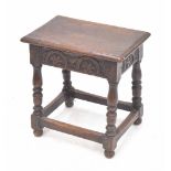 Oak joynt stool, with moulded top over carved frieze, on turned legs united by stretchers, 18" wide,