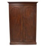 Late 19th century/Edwardian mahogany linen press, the moulded cornice over two long panelled doors