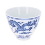 Chinese blue and white porcelain tea bowl, decorated with band of two dragons among clouds, raised