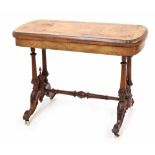 Victorian walnut fold-over games table, the rounded rectangular folding top enclosing green baize