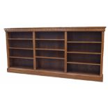Large narrow oak open shelved bookcase with carved decoration, 109" wide, 12.5" deep, 51" high
