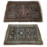 Two similar Persian rugs, the first on a natural ground with geometric panel within multiple bor