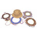 Collection of four African beaded and shell mount wide necklaces; also a woven trilby hat (5)