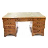 Reproduction walnut twin pedestal desk, the moulded top with inset green tooled leather writing