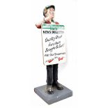 Lifesize vintage advertising news boy, cast resin, holding an advertising sandwich board, on