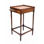 Regency style mahogany tray top night table, the wavy rim gallery over two pull-out candle slides to