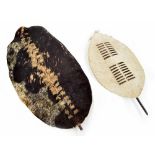 Zulu tribal Nguni cow hide shield, 45" high, 24" wide; together with a smaller hide shield, 29"