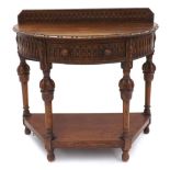 Carved oak demi lune side table, with raised back and single freize drawer, raised upon carved