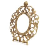 Gilt metal pierced scrolling strut picture frame, oval aperture 5.5" high, 4" wide, frame 11" high