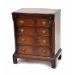 Small mahogany bachelor chest of drawers in the Georgian manner, the fold-out baize lined top over