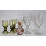 Pair of cut glass wine glasses, the bowl half cut under an etched fruiting vine border around an