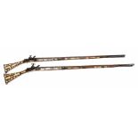 Two similar antique Indo-Persian flintlock muskets, the stocks ivory inlaid, the octagonal barrels