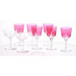 Set of six Art Deco cranberry sherry glasses, raised on clear hexagon stem, 5" high; together with