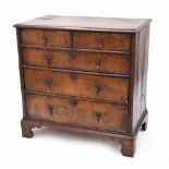 Early 18th century walnut inlaid chest of drawers, the quarter veneered moulded top over two short
