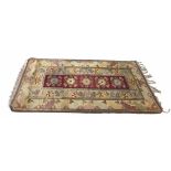Persian pattered natural ground rug, decorated with central five floral medallion panel within