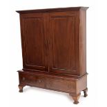 Large mahogany bookcase, the moulded cornice over two panelled and boxwood inlaid doors enclosing