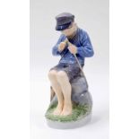 Royal Copenhagen - figure of a seated shepherd boy whittling a stick, factory stamp and inscribed '