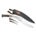 Early 20th Century Burmese Kukri knife, complete with further two small knives in canvas wrapped and