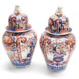 Pair of 19th century Japanese Imari porcelain jars and covers, 15" high (one cover damaged, repair