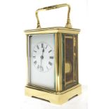 Brass striking carriage clock, the white dial with Roman numerals and blued steel hands within a