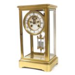 French brass four glass two train mantel clock striking on a bell, the 3.5" white enamel chapter