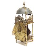 Antique brass lantern clock, the 5.5" chapter ring enclosing a foliate engraved centre signed