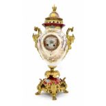 French novelty porcelain and ormolu mounted two train vase clock, the movement striking on a bell,