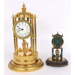 Large gilt metal torsion clock, the 3.5" floral painted cream dial suspended in a circular fluted