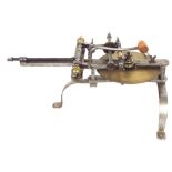 Antique brass and steel wheel cutting engine, supported upon arched steel legs, 18.5" long overall