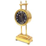 Brass gravity clock stamped verso British Make, Pat 15238/19, with 3" glazed dial, supported upon