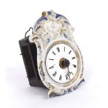 Miniature Black Forest clock timepiece, with white enamel dial within a porcelain foliate moulded