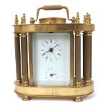 Brass cased two train alarm mantel clock striking on a bell, within a pillared case with rounded