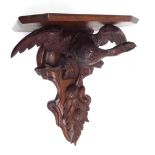 Oak clock wall bracket, carved with an eagle support over fruiting foliage, 12.75" wide, 9" deep