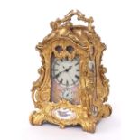 Reproduction ornate gilt metal and porcelain panelled striking carriage clock with alarm, 9.5" high