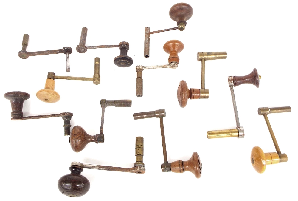 Twelve brass and steel clock winding keys with turned wooden handles (12)