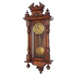 Walnut Vienna regulator two train wall clock, the 5" gilt repousse dial within a glazed pillared