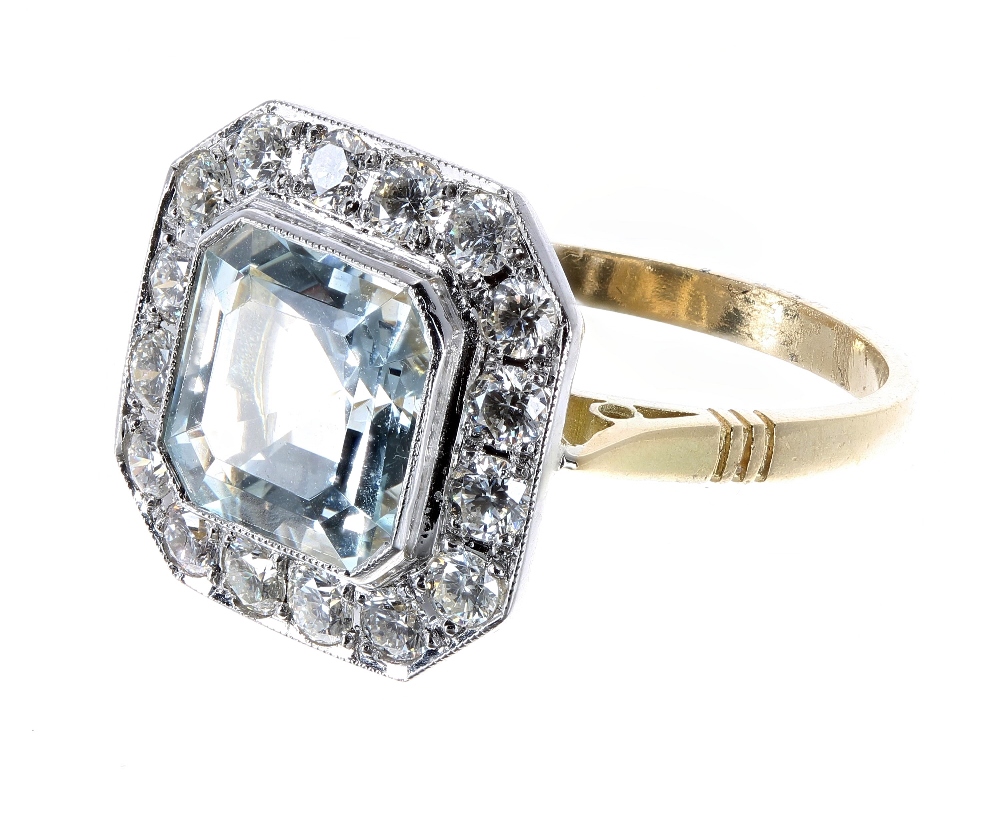 18ct aquamarine and diamond cluster ring, the aquamarine 2.30ct, in a surround of round brilliant-