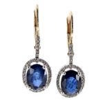 Pair of 18ct sapphire and diamond drop cluster earrings, each set with oval blue sapphires, 1.93ct