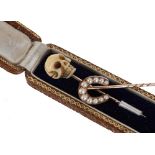 Novelty antique gold and ivory scull stick pin in case, the scull 14mm; also another horseshoe pearl