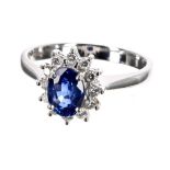 Modern 18ct white gold sapphire and diamond oval cluster ring, the sapphire of good colour in a