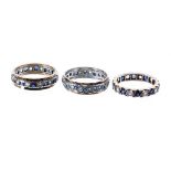 Three 9ct gem set full eternity rings, 10.9gm in total (3)