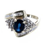 14ct sapphire and diamond cross over ring, the sapphire 0.80ct approx, in a diamond setting of round