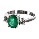 18ct white gold emerald and diamond three stone ring, the oval emerald 1.70ct approx, flanked with
