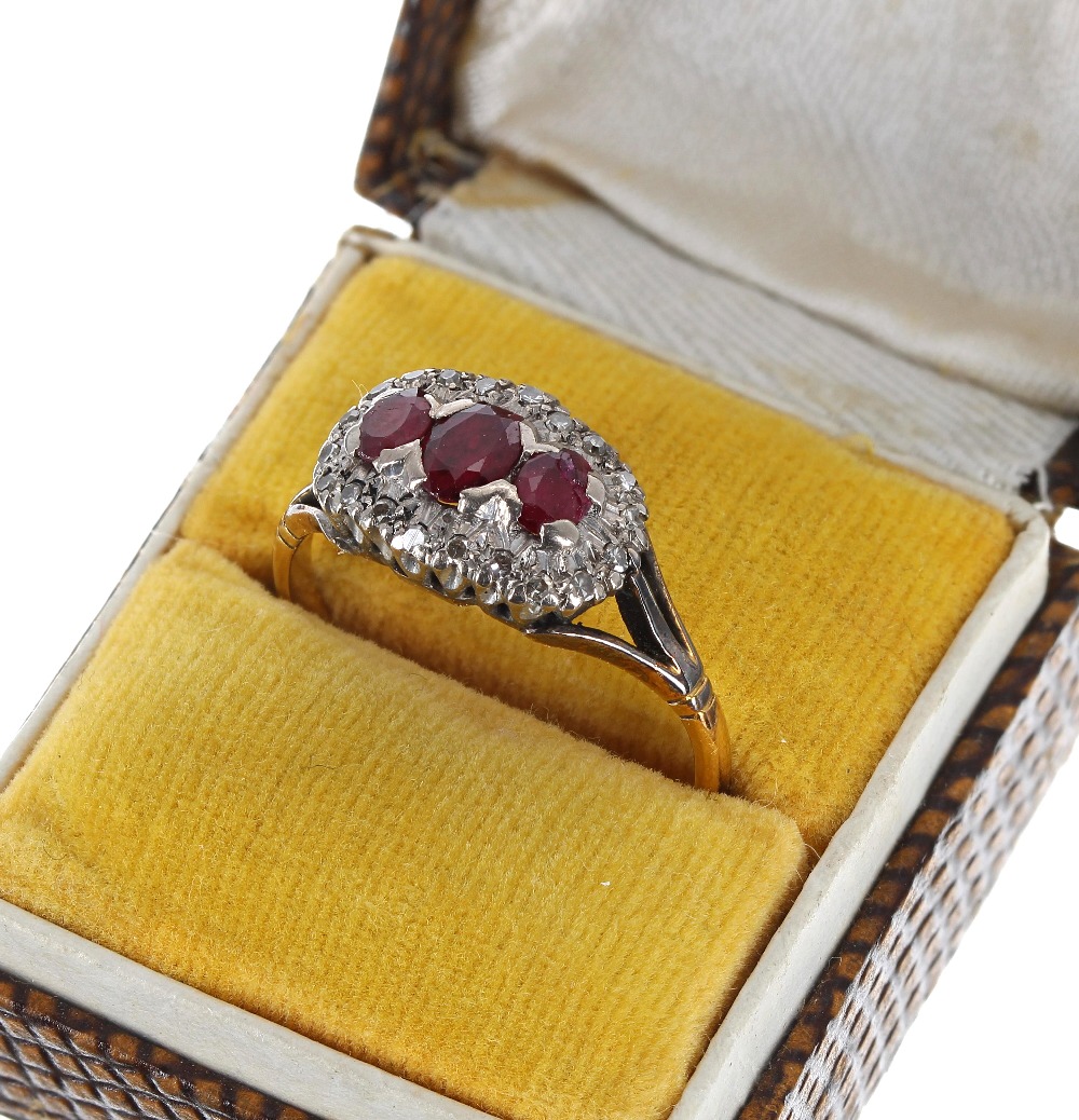 18ct ruby and diamond boat shaped cluster ring, with three oval rubies in a diamond claw setting, - Image 2 of 2