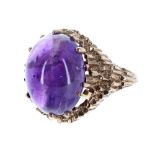 9ct amethyst cabouchon ring in the manner of Andrew Grima, London 1970, the amethyst 16mm x 12mm,