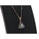 Triangular rough-cut diamond pendant on a slender 9ct necklace, the pendant 16mm, 7.2gm