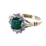 18ct emerald and diamond cluster ring, the emerald 0.66ct approx, in a setting of twelve diamonds,